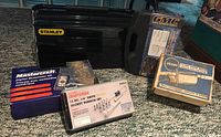 Photo of Stanley toolbox with boxed Mastercraft digital multimeter kit, Craftsman socket wrench set, GMC drill bit sets and Do Ray inline engine heater boxes arranged in front