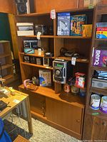 Full view of wooden cabinet filled with various objects demonstrating size and layout.