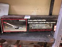 Box of Mastercraft 2 ton cable hoist puller showing product image and branding.