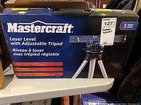 Box showing Mastercraft brand and product name 'Laser Level with Adjustable Tripod'.