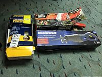 Lot overview showing three boxed items: Black & Decker cordless garden shears, Weser Power keyless entry set, and Mastercraft compact reciprocating saw.