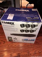 Box showing front and side with product branding and camera images.