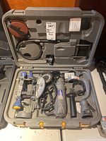 Opened hard plastic carrying case containing the Mastercraft Maximum spin saw kit with all components arranged in molded slots: motor unit, saw guide, handles, blade attachment, and power cord visible.