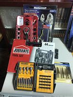 Overview of all tool sets including Jobmate red case, Mastercraft pliers and wrench set, Rockwell screwdriver bits, step drill bits, and loose bits.