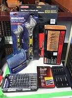 Overview of all tools in original packaging including wrenches, pliers, Forstner bit set, screwdriver bits and nut driver sets