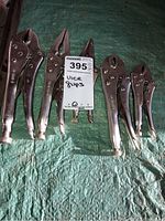 Full set of six vice grip pliers arranged on a tarp, showing different sizes and types