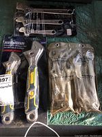 Photo showing three wrench sets including Mastercraft adjustable wrenches, SAE and Metric fixed wrenches in original packaging.