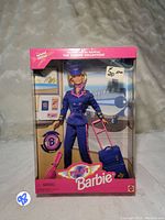 Front view of the boxed 1997 Pilot Barbie doll showing the full packaging and Barbie inside with luggage accessory.