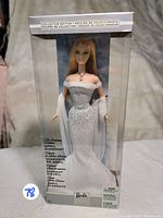 Front view of boxed April Diamond Barbie Doll showing clear packaging and doll in silver gown with shawl.