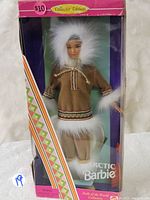 Front view of Arctic Barbie doll in original box showing detailed traditional Inuit clothing with white fur trims and brown parka.