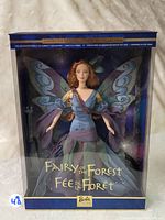 Front view of the Barbie Fairy of the Forest doll in the sealed collector box, showing doll with wings and gown.