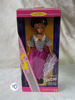 Front view of the French Barbie doll in original packaging, showing the doll dressed in pink and white with lace details and floral decorations on the box.