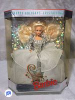 Front view of the Barbie doll inside the original packaging showing the doll in the white and silver crystalline gown with holographic background detail.