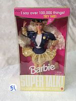 Front view of Portuguese Super Talk Nina Barbie doll in original box with text 'I say over 100,000 things! TRY ME!' and Barbie branding