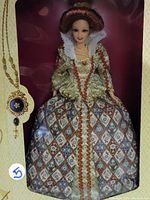Barbie doll dressed as Queen Elizabeth I in colorful Elizabethan gown with white ruffled collar, displayed inside original packaging box.