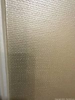 Close-up of textured pattern showing basket-weave vinyl surface
