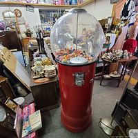 Front view of red Beaver bubble gum vending machine with acrylic globe filled with gumballs