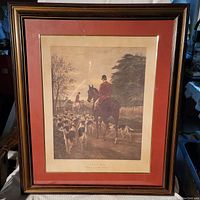Framed aquatint engraving showing the hunting scene with riders on horseback and pack of hounds returning to the kennels during evening.