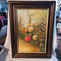 Full view of the framed oil painting depicting fruits with textured brushstrokes and warm tones.