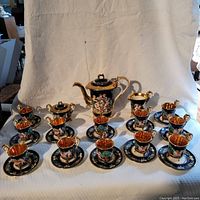 Full set arranged showing all pieces: teapot, sugar bowl, creamer, cups and saucers.