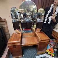 Front view of the vintage walnut dressing table with triple waterfall vanity mirror and two pedestal base units with drawers.
