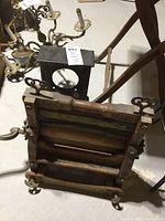 Photo of the antique wringer and mantel clock body showing their physical condition and details.