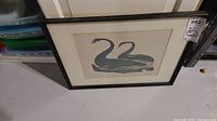 Front view of framed print showing two swans and frame