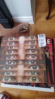 Photo showing stack of vinyl LP records including Blood, Sweat & Tears 'Mirror Image' with repeated eye pattern on cover.