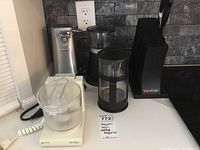 Overview of the lot showing can opener, coffee grinder, French press, knife block, and chopper.