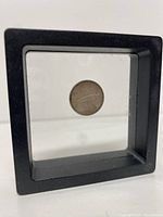 Front view of the 1967 Canadian dime in a black-framed transparent holder.