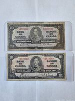 Front view of two 1937 Canadian ten dollar banknotes stacked vertically in protective plastic holders, showing serial numbers UD3570046 (top) and LT2472593 (bottom).
