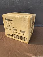 Closed cardboard shipping box labeled Memorex Mini DVD Accessories Kit containing the cases.