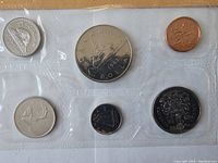 Coins arranged in a flat transparent plastic holder, showing obverse and reverse sides with all six coins visible.