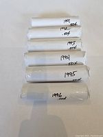Photo of six white paper rolls labeled with years 1991-1996 and 50 cents per roll, arranged vertically on a white background.
