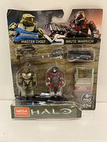Packaging front view showing the Master Chief and Brute Warrior figures with weapons and accessories, Mega Construx branded with Halo series.