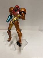 Front angled view of the Samus Aran Figma figure showing upper body armor and arm cannon with clear display stand.