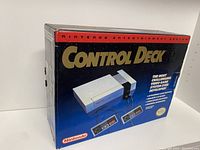 Front of the Nintendo Entertainment System Control Deck original box showing console and controllers graphics and Nintendo branding
