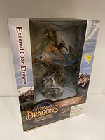 View of boxed McFarlane Eternal Clan Dragon figure showing front of the box with branding and window display of figure inside.