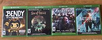 Front covers of 4 Xbox One games: Bendy and the Ink Machine, Sea of Thieves, Marvel Avengers, Battlefield 2042