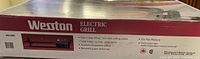 Weston Electric Grill WS 200 box close-up showing brand name and product image with features listed on the front and side panels.