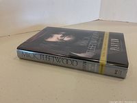 Side angle showing the spine and front of hardcover autobiography Play On by Mick Fleetwood with dust jacket.