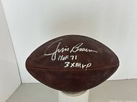 Side view of Wilson Duke NFL football displaying Jim Brown's silver signature and inscriptions