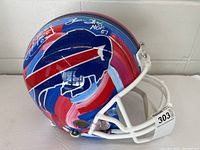 Left-side view of full-size Buffalo Bills helmet with hand-painted red, white, and blue brush strokes
