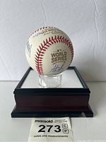 Frontal view of the signed 2016 World Series baseball on display case