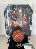 Basketball displayed in front of framed Cavaliers collage.