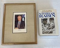 Overhead view of the book and framed photograph side by side