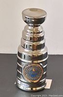 Front view of chrome-finish miniature Stanley Cup showing signature, Edmonton Oilers logo and numbered base