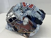 Side view showing painted cracked-ice graphics, Canadiens logo and silver cage