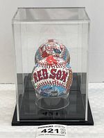 Baseball inside clear acrylic display case on black base, full lot view