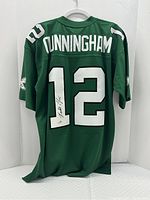 Rear view of green jersey showing CUNNINGHAM nameplate and white number 12 with Randall Cunningham signature on the '1'